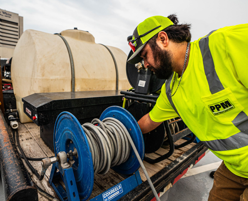 Side view of man operating cleaning machinery