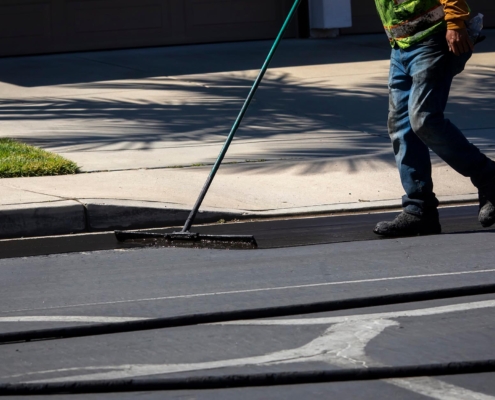 Worker sealcoating public street