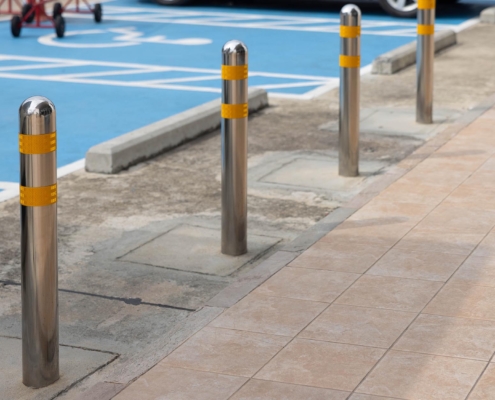 Metal bollards lined up in parking lot